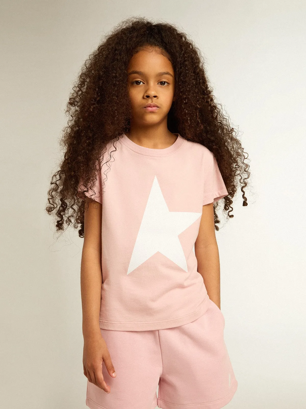 T-shirt rosa da bambina con logo e maxi stella di colore bianco