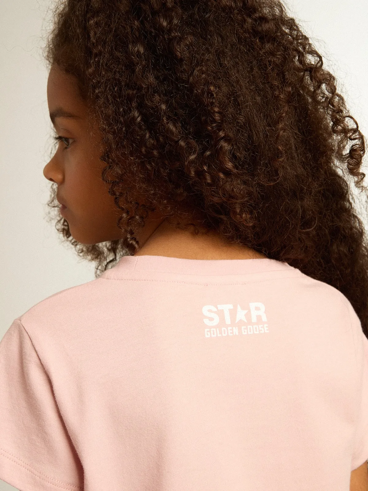 T-shirt rosa da bambina con logo e maxi stella di colore bianco